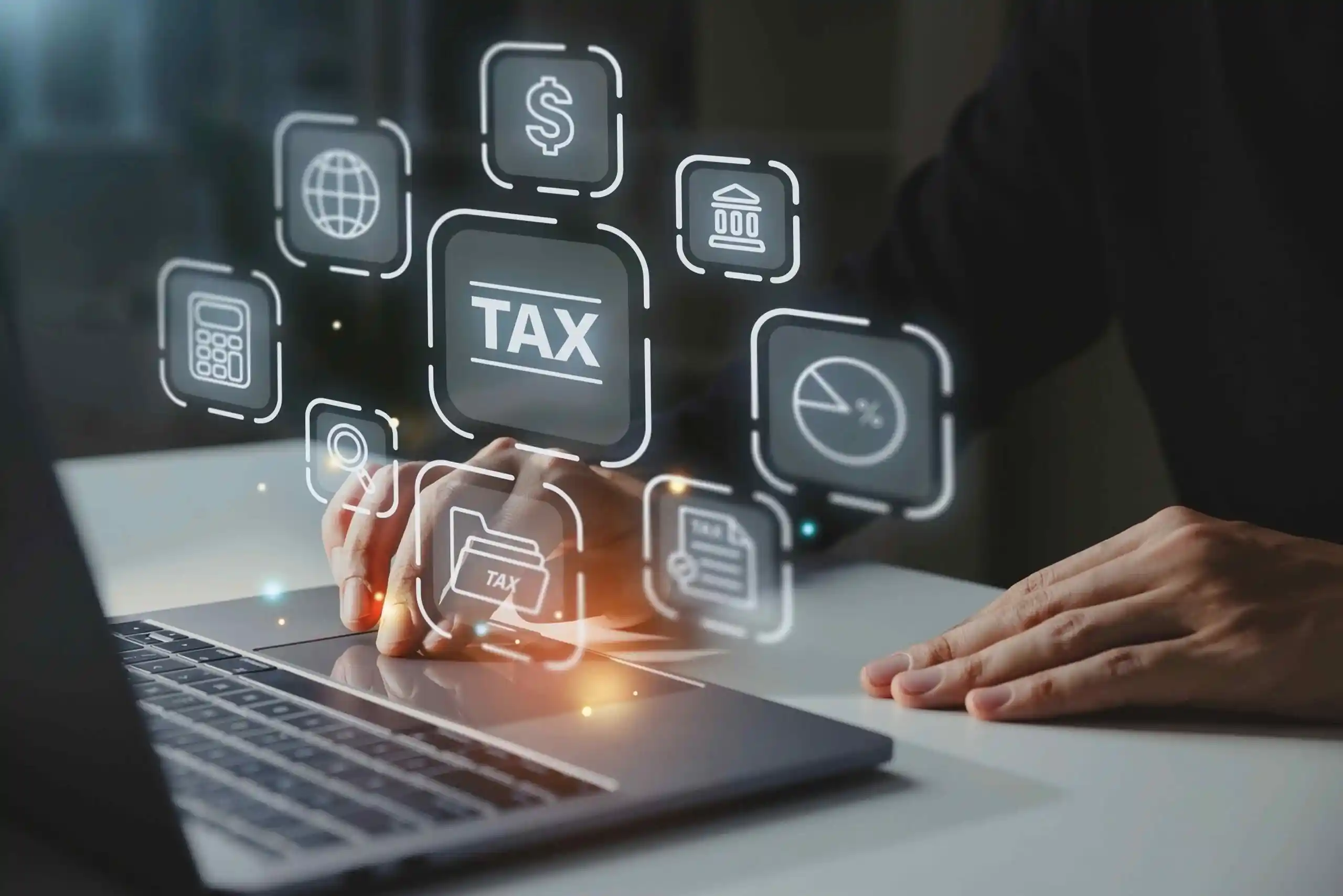 Person using a laptop with tax, banking and global finance icons